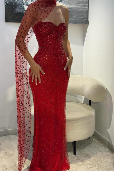 Back view of the red strapless mermaid gown with a flowing train.