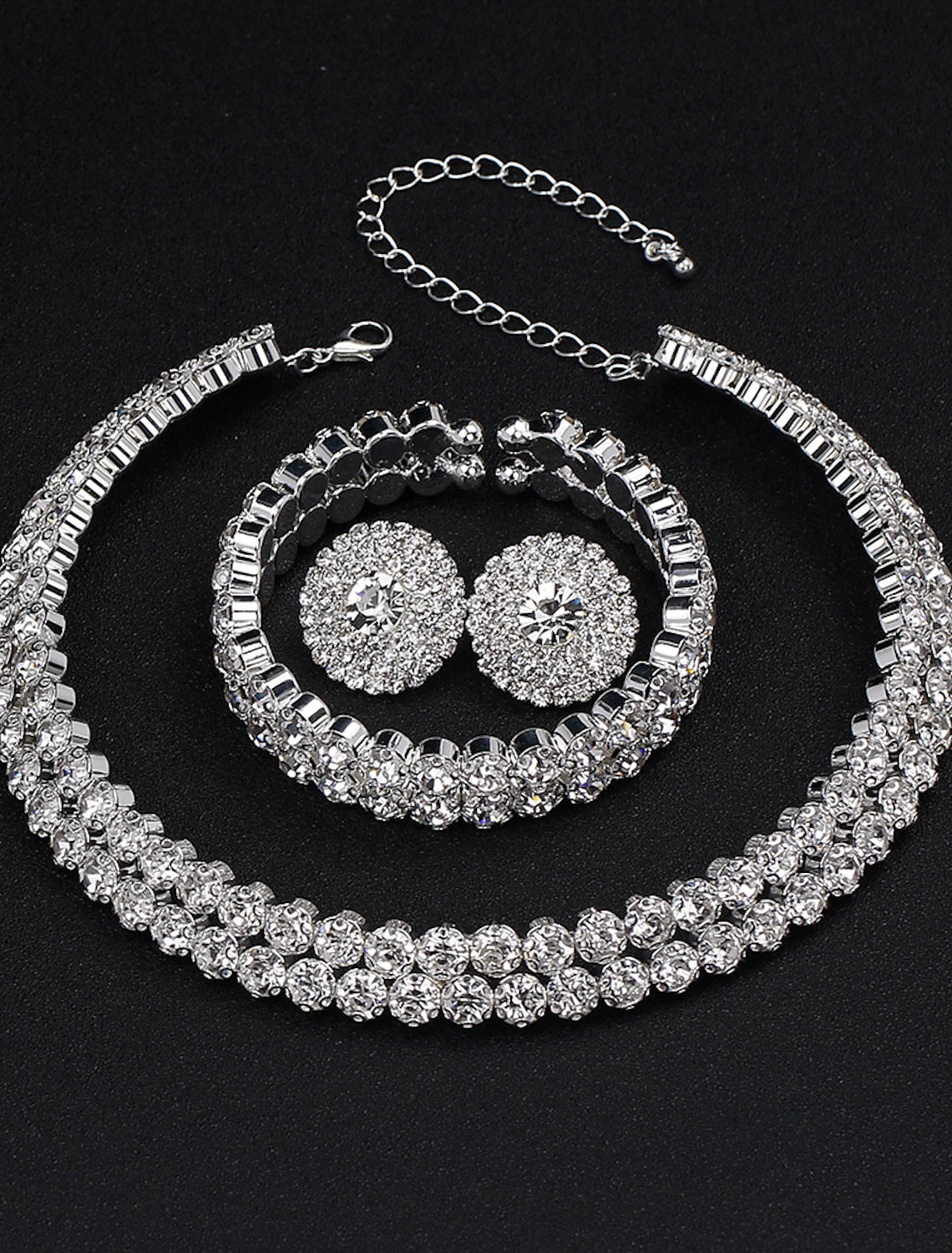 Woman wearing a rhinestone alloy bridal jewelry set, including a necklace, earrings, and bracelet.