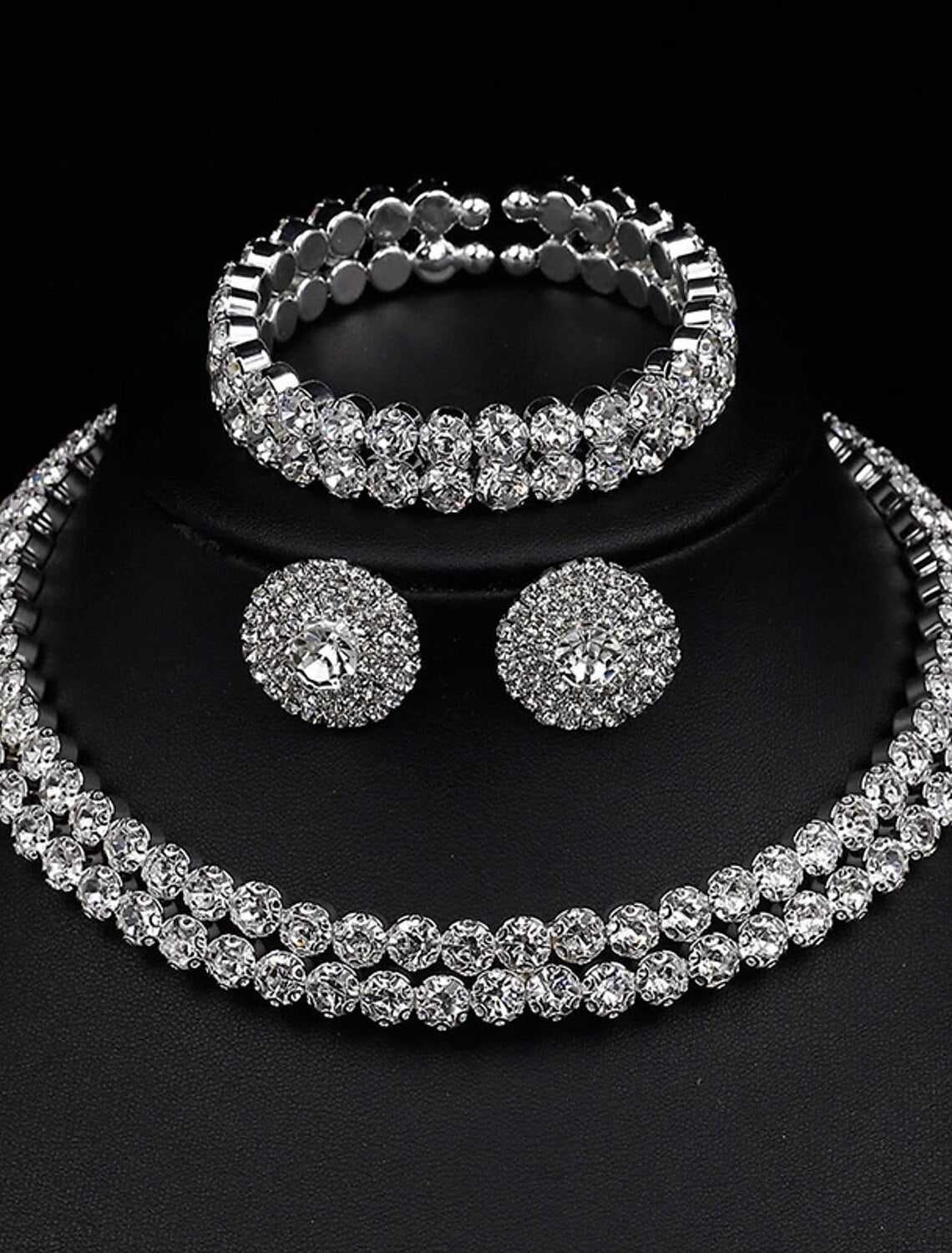 Close-up of the rhinestone alloy necklace and matching earrings from the bridal set on a white background.