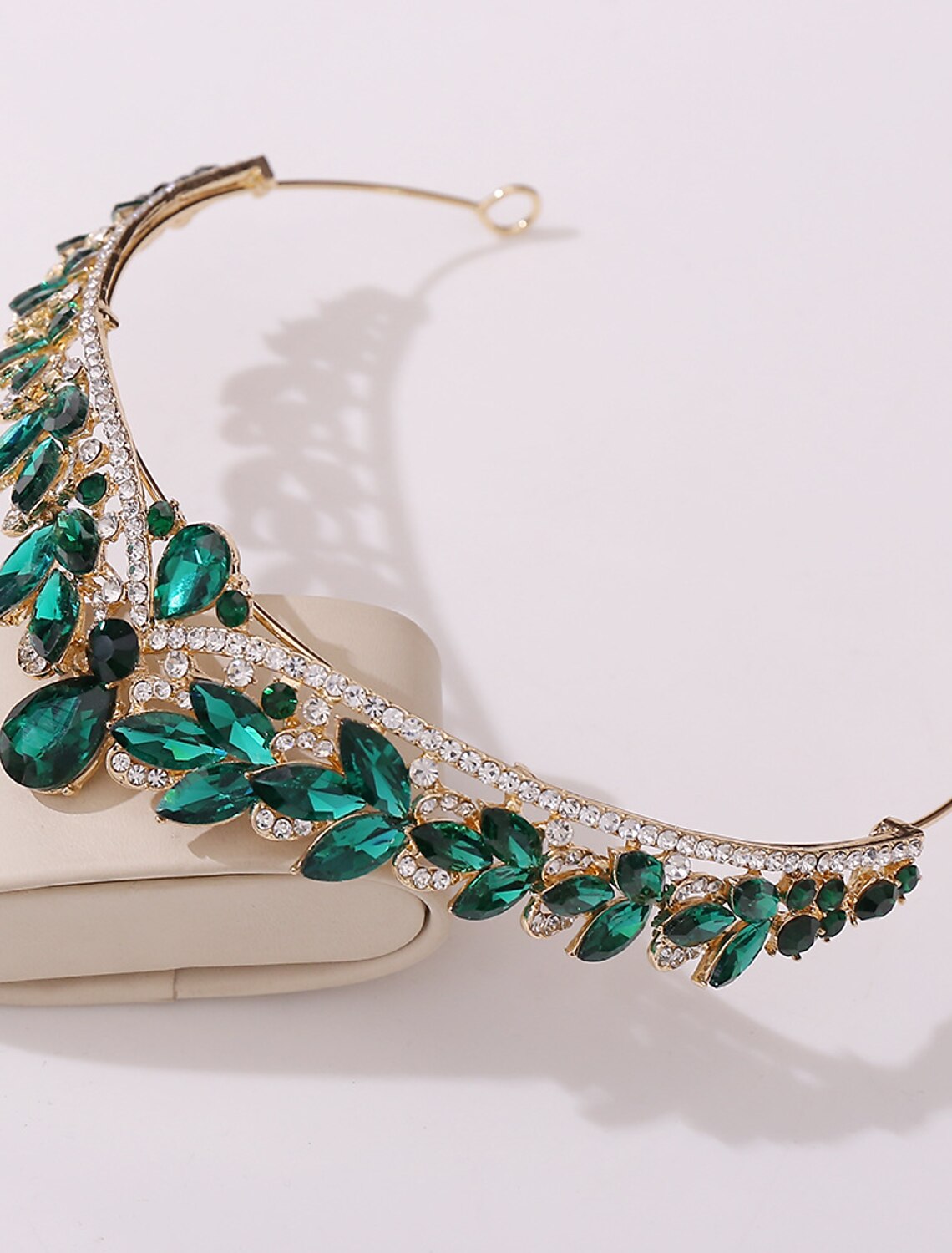 Rhinestone alloy crown tiara headband from an angle, showing its elegant curve and crystal arrangement.