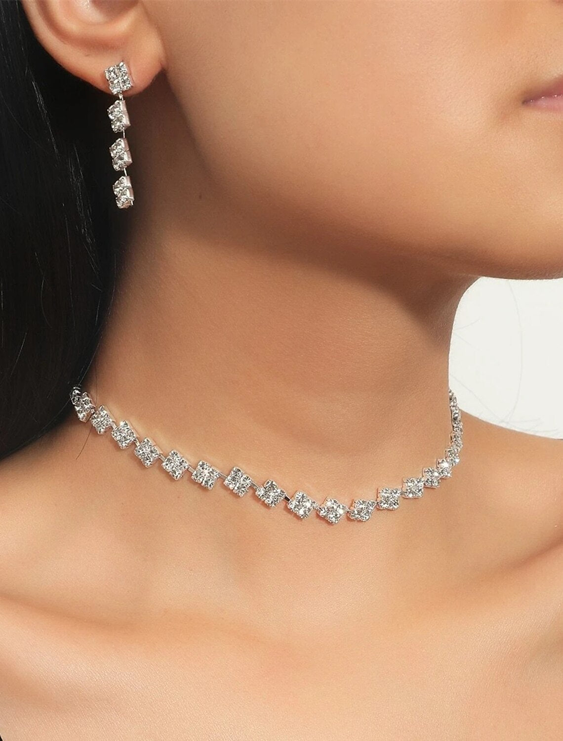 Close-up of elegant rhinestone alloy drop earrings.