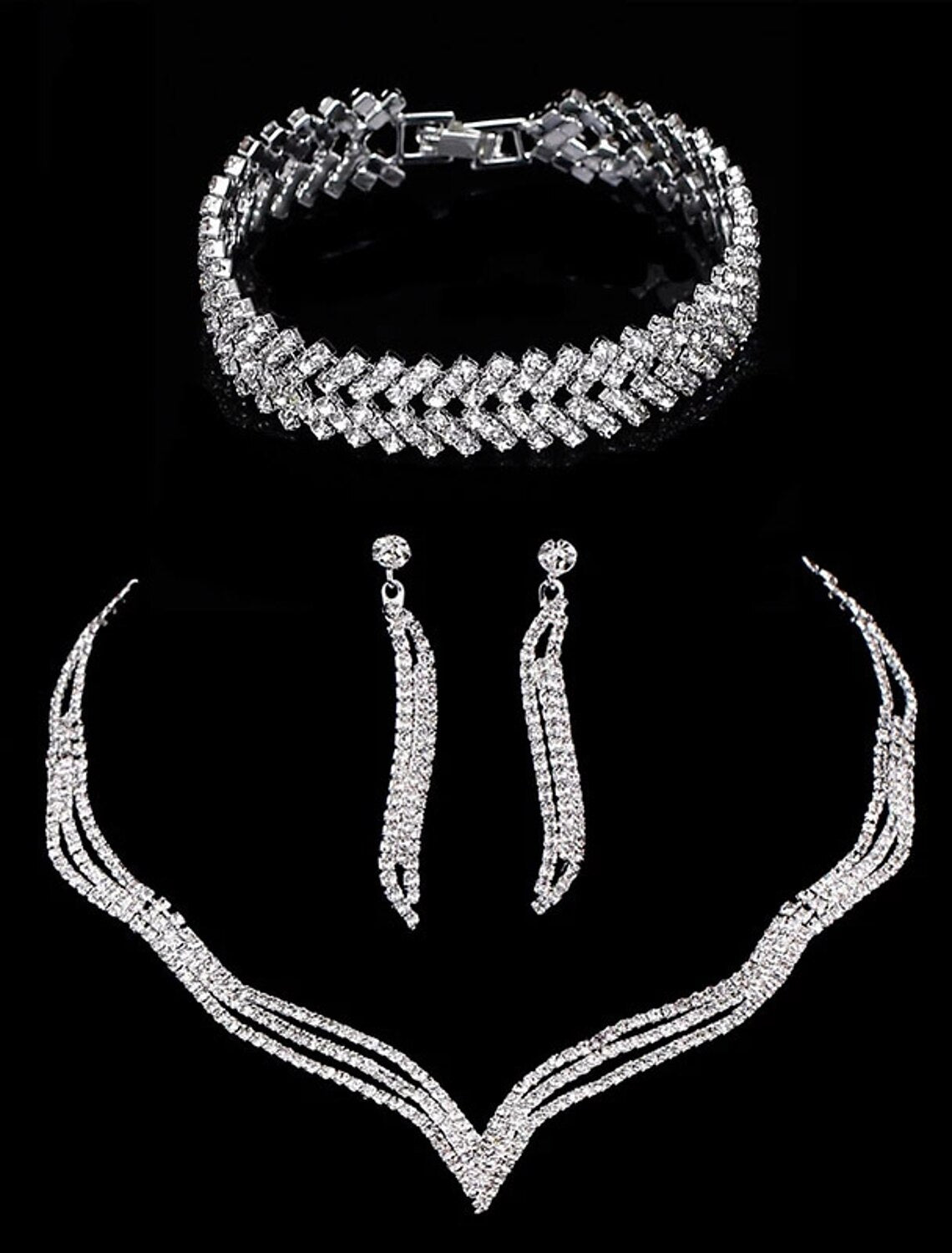 Model wearing a sparkling rhinestone bridal necklace, bracelet, and earrings set.