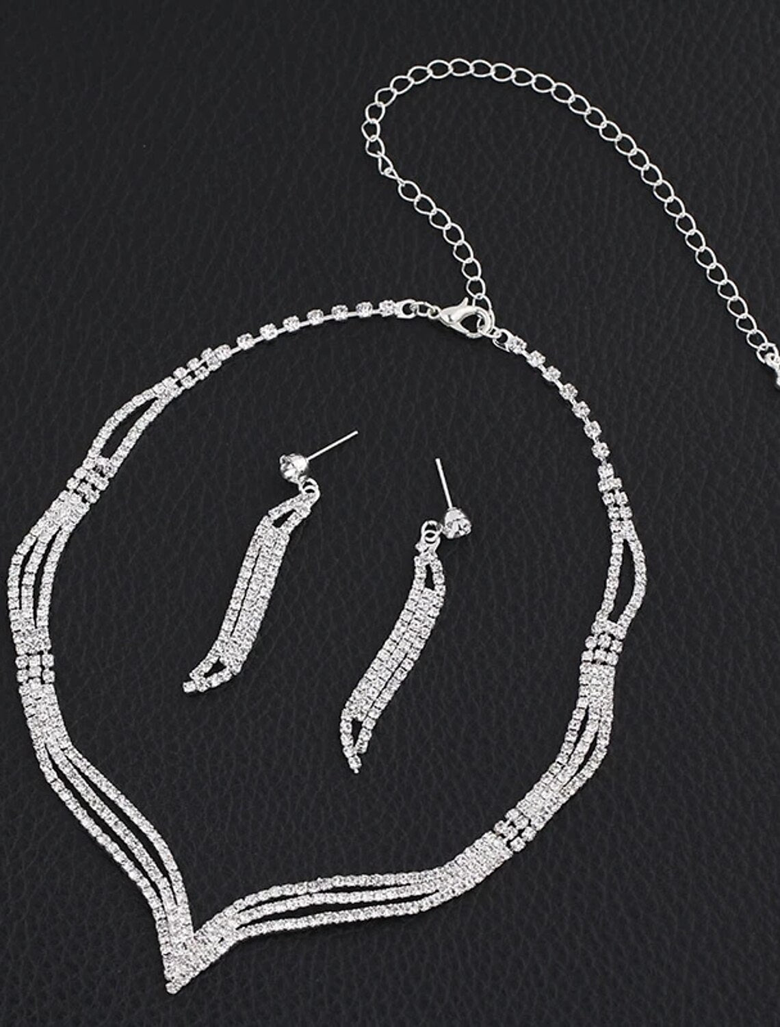 Close-up of rhinestone bridal necklace and matching earrings.