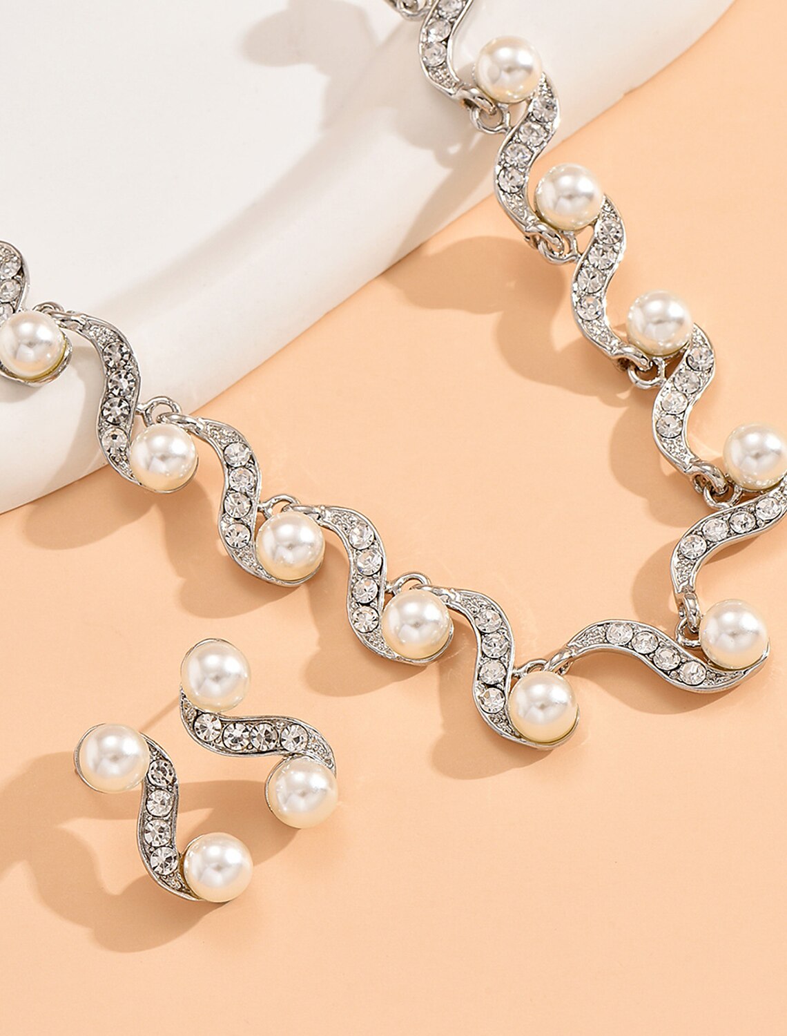 Detailed view of the rhinestone bridal earrings, designed to complement the necklace.