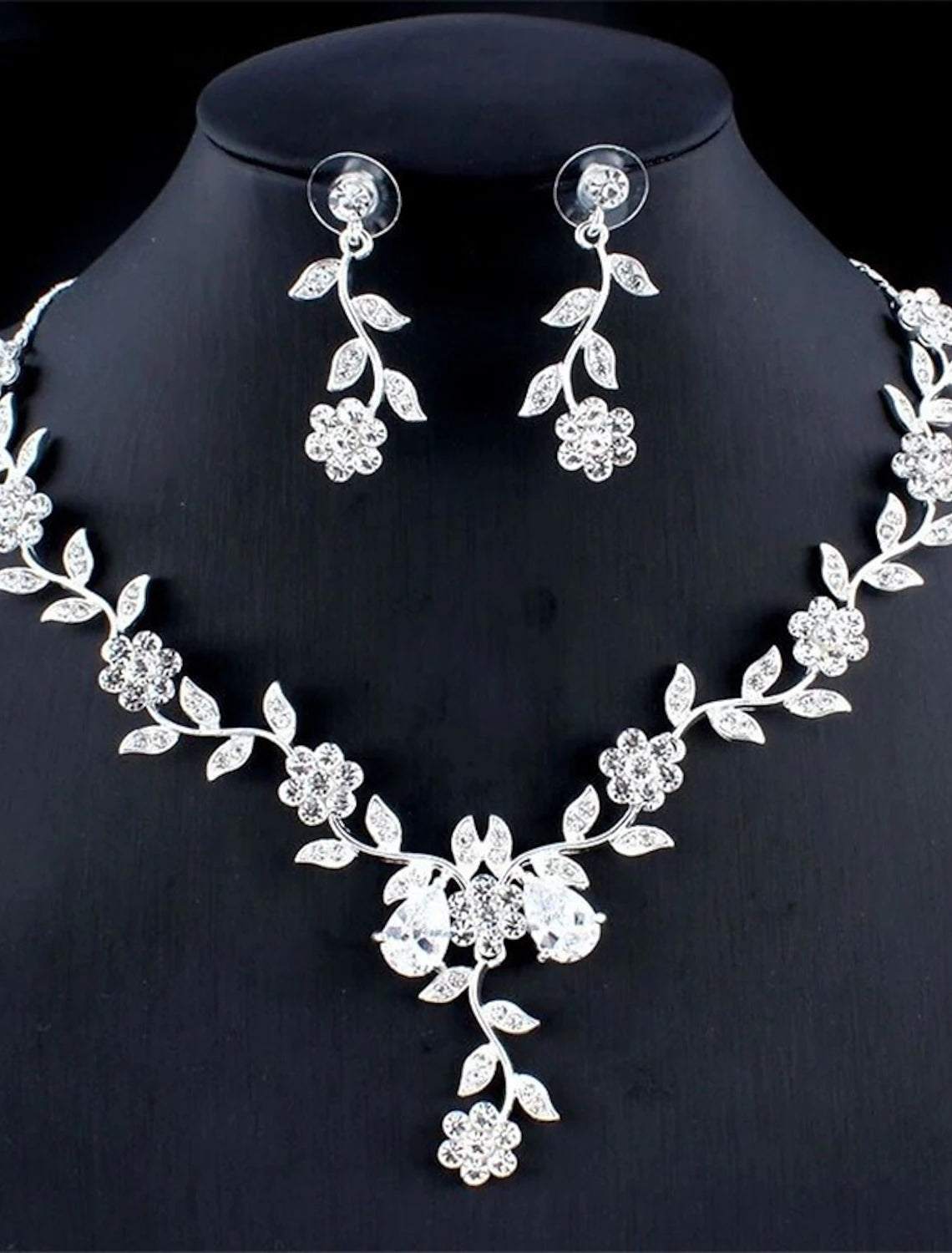 Elegant rhinestone bridal jewelry set with floral design.