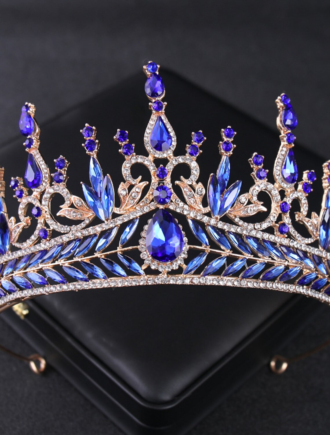 Side view of a crystal and rhinestone tiara headband.
