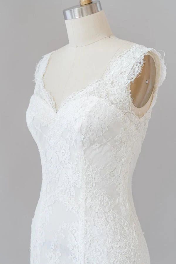 Full length view of a bride in a lace mermaid wedding gown.