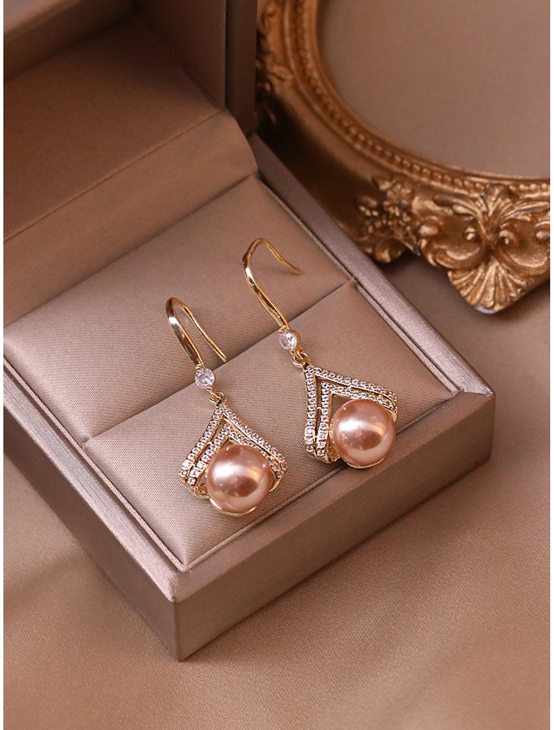 Side profile of a rose gold pearl stud earring.