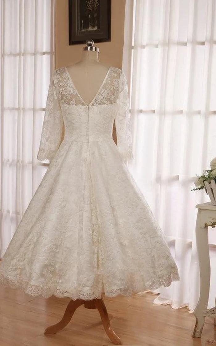 Model wearing an elegant tea length lace wedding dress.