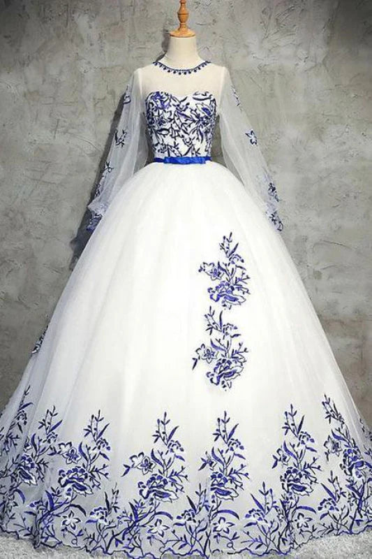 Model wearing an elegant long sleeve prom dress with tulle appliques.