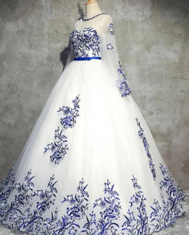 Back view of a long sleeve formal gown with intricate tulle appliques.