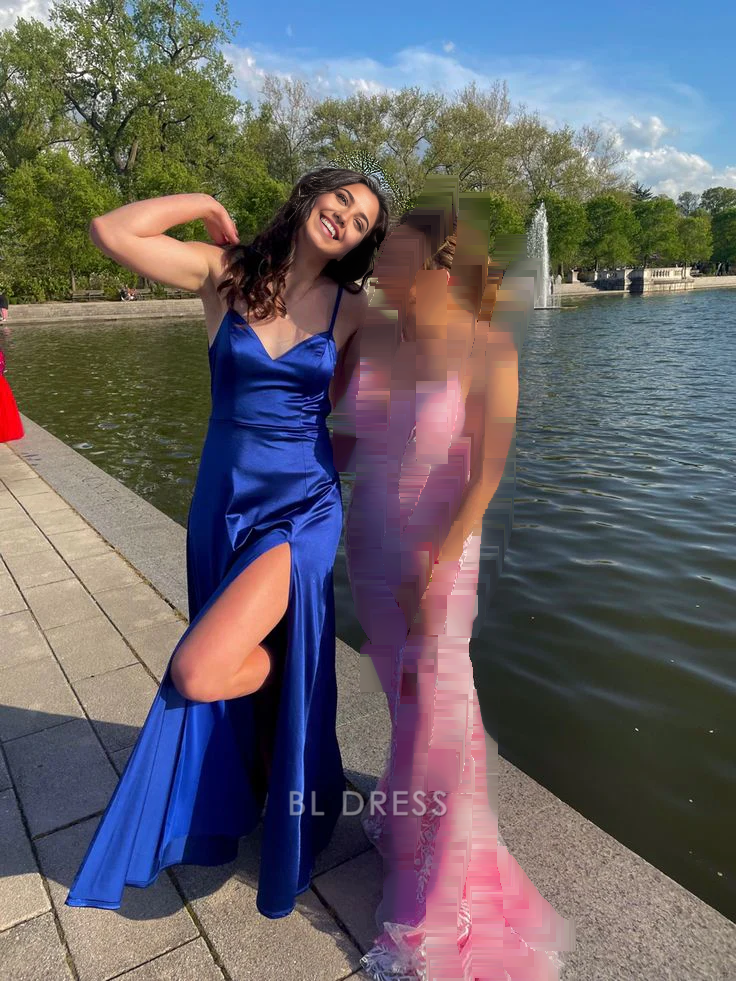 Royal blue mermaid prom dress with spaghetti straps and a side slit.