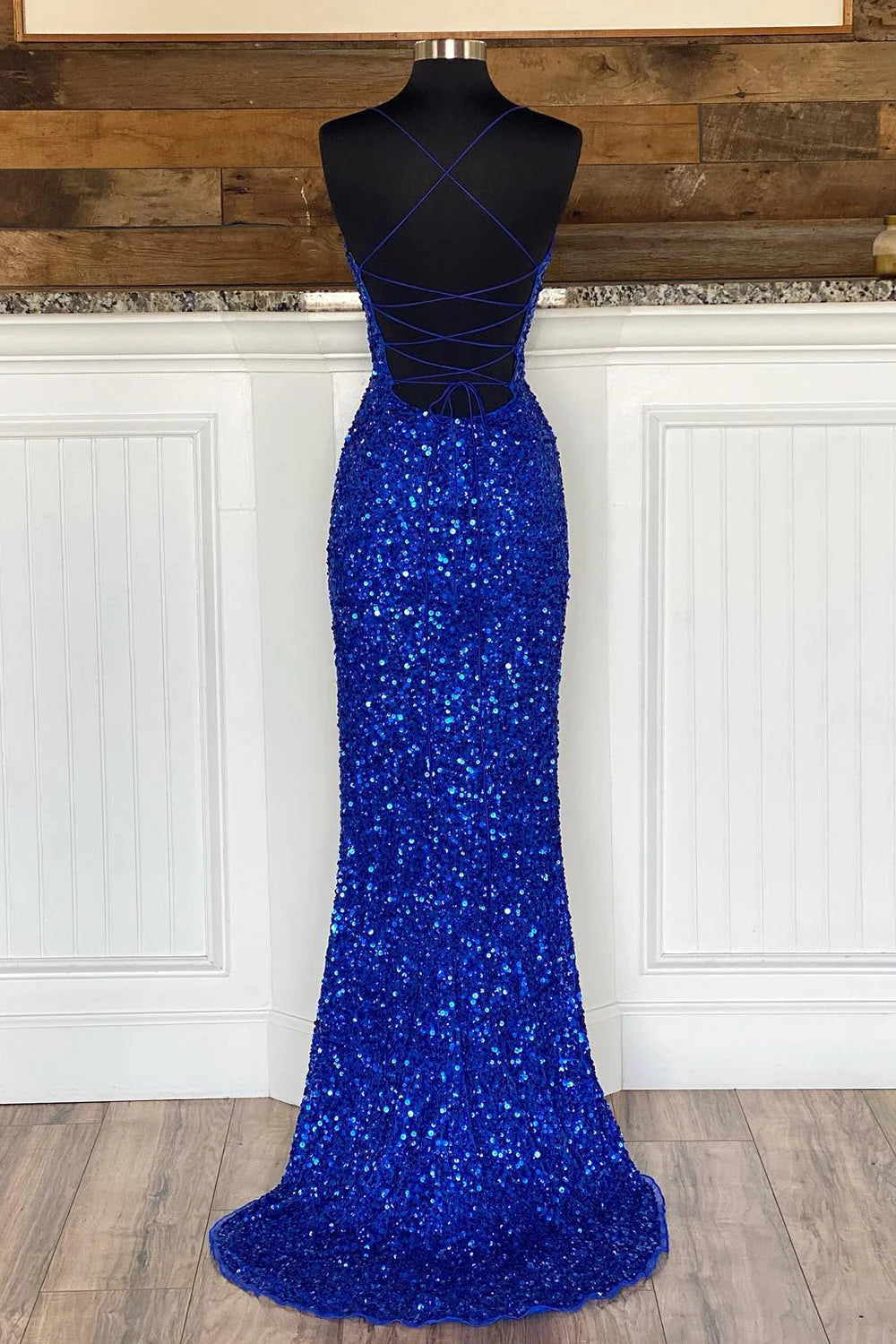 Back view of the royal blue mermaid sequin gown, showcasing its long silhouette.