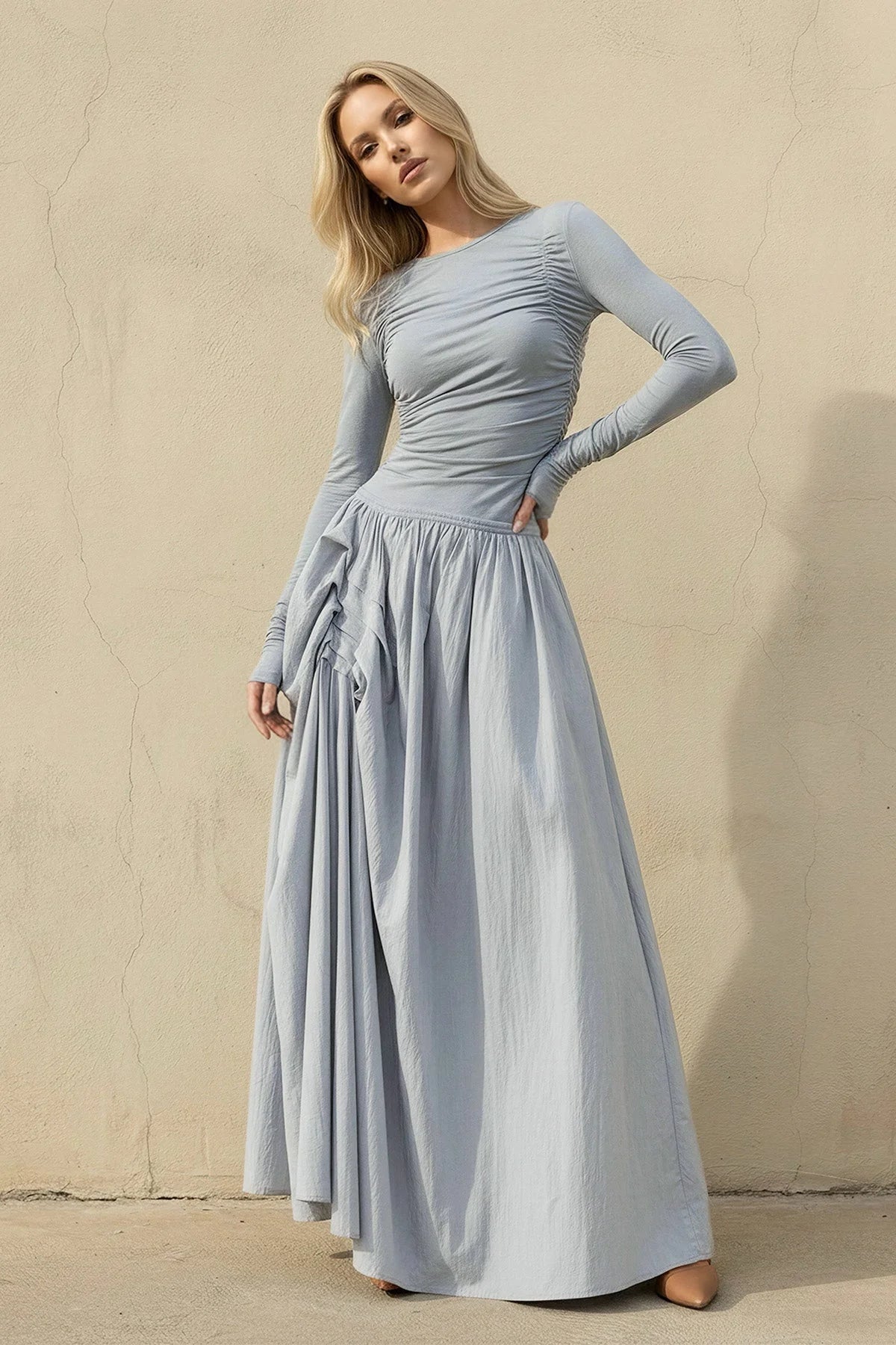 Model wearing an elegant long sleeve ruched bodice A-line velvet gown.