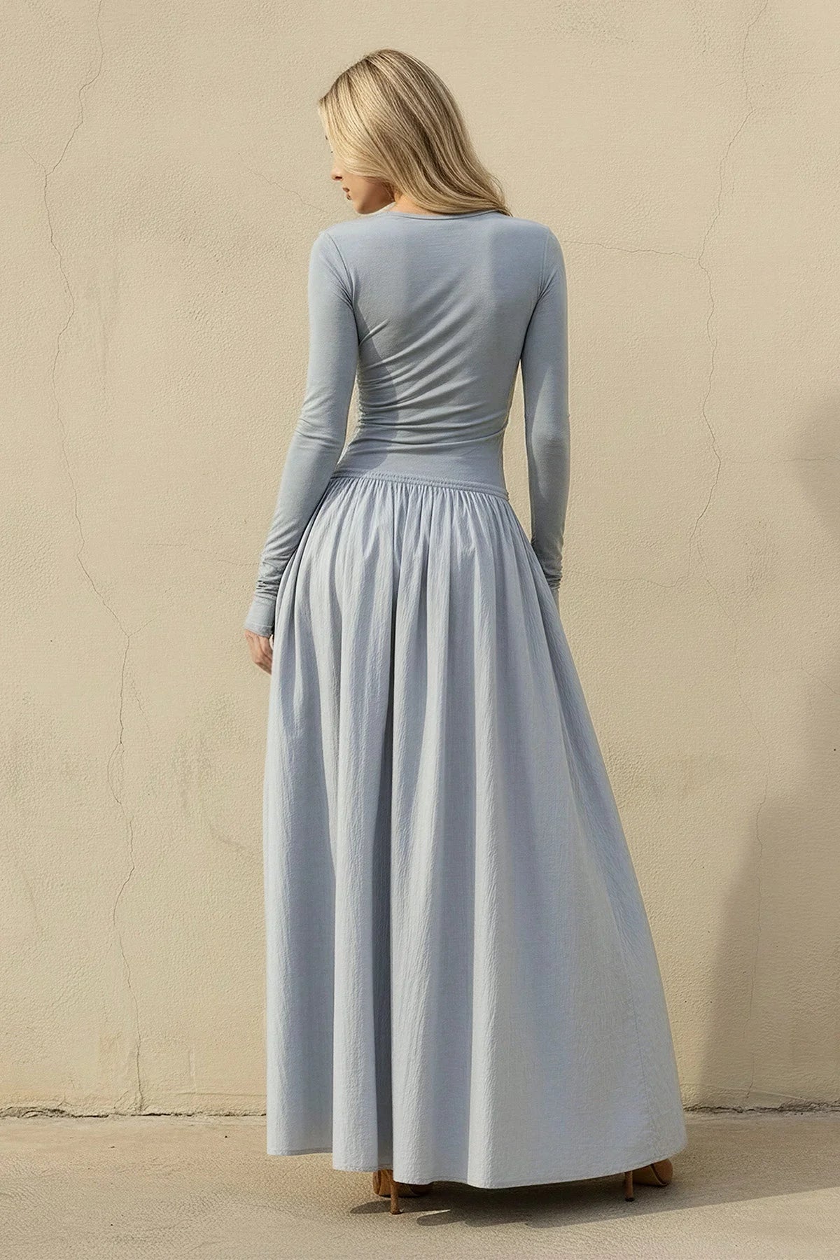 Full view of the flowy A-line skirt and floor length of the elegant velvet gown.