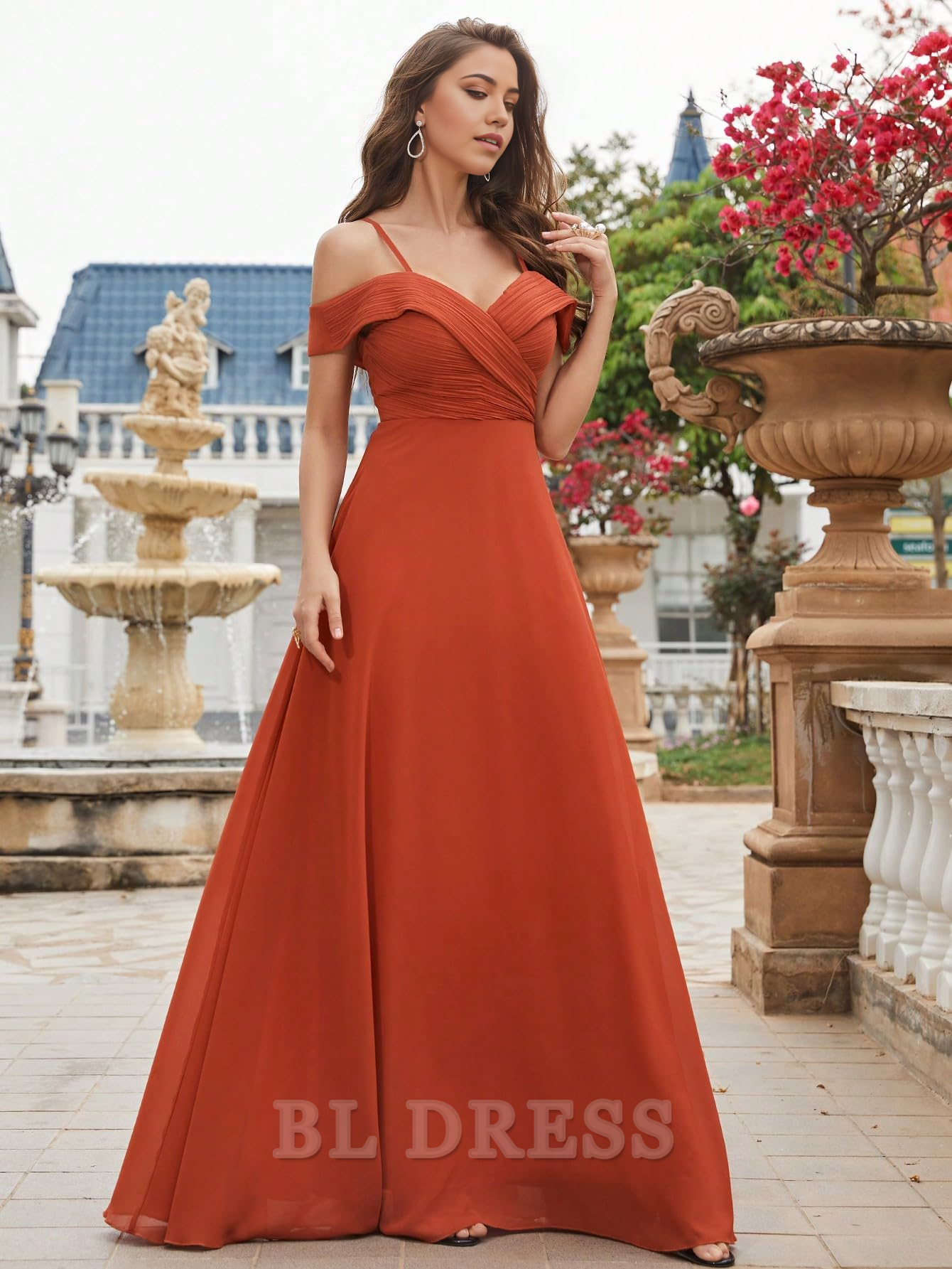 Side view of a woman in a V-neck cold shoulder formal gown.