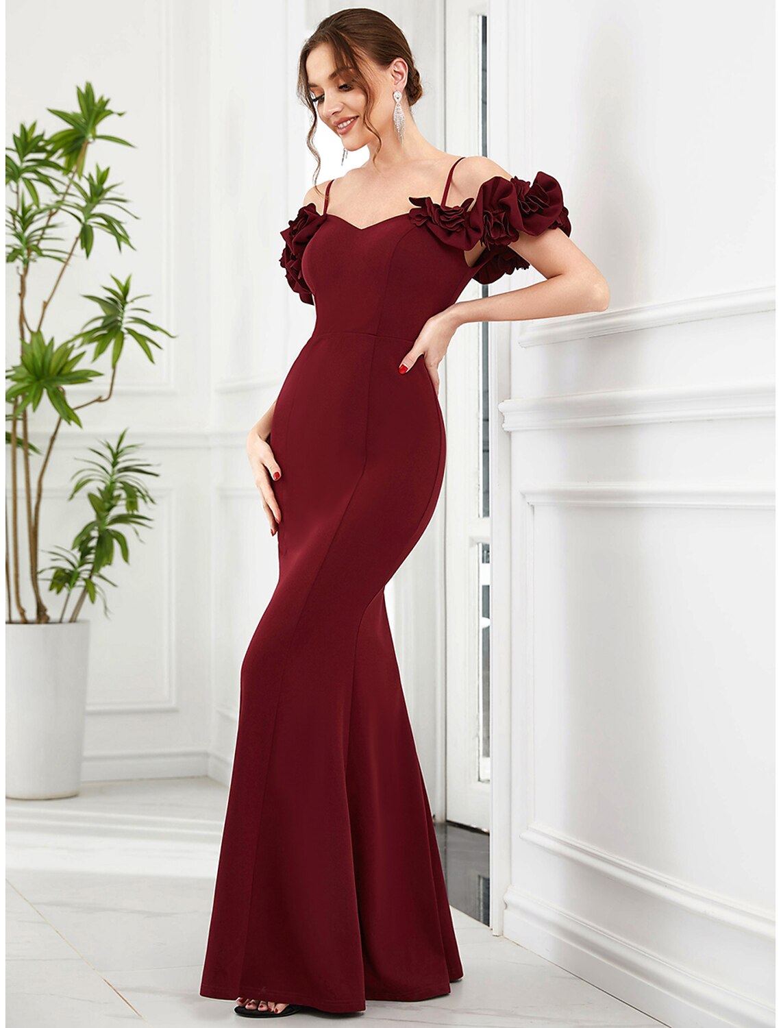 Side view of a floor-length ruffled Mermaid Trumpet dress.