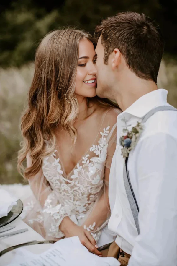 Side profile of the elegant A-line V-neck long sleeve bridal gown.