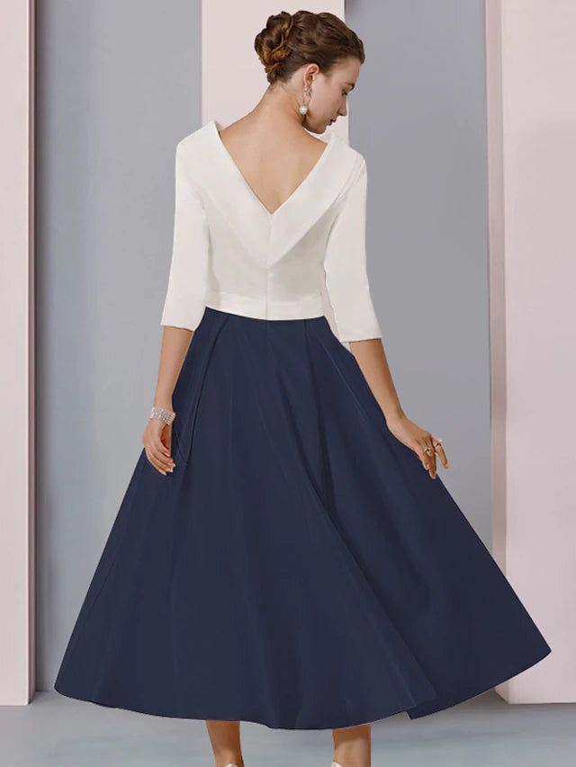 Detail of the crystal brooch and half sleeve on the elegant satin dress.