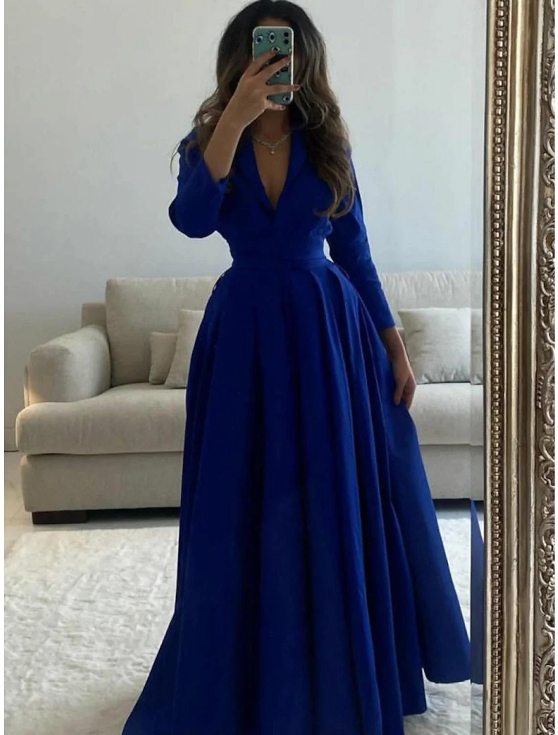 Elegant green satin A-line evening gown with V-neck and 3/4 sleeves.