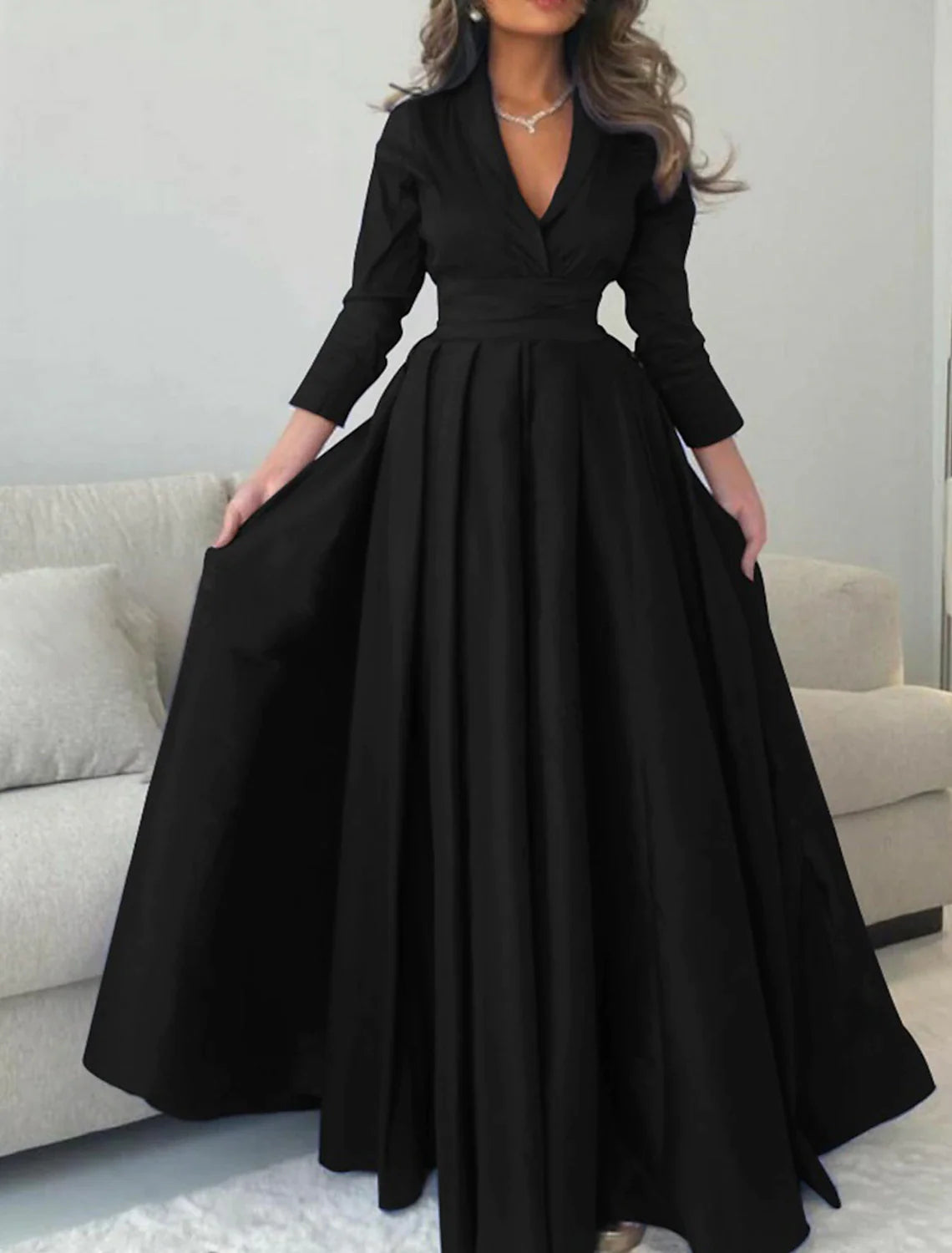Back view of a floor-length satin A-line evening gown.