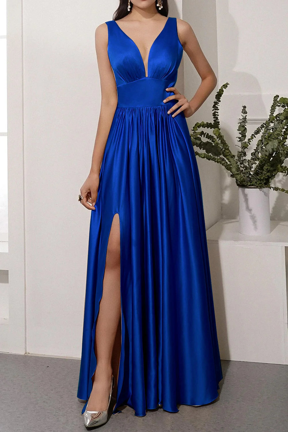 Sleeveless satin prom dress with a flattering silhouette and slit detail.