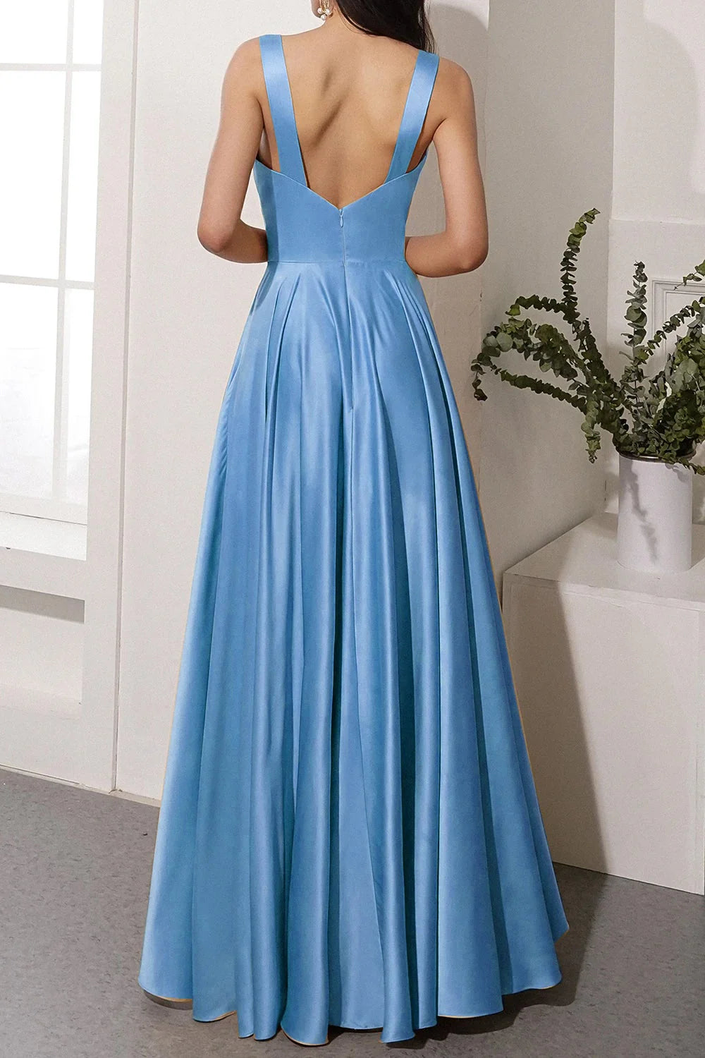 Satin evening gown featuring a high slit and sleeveless design.