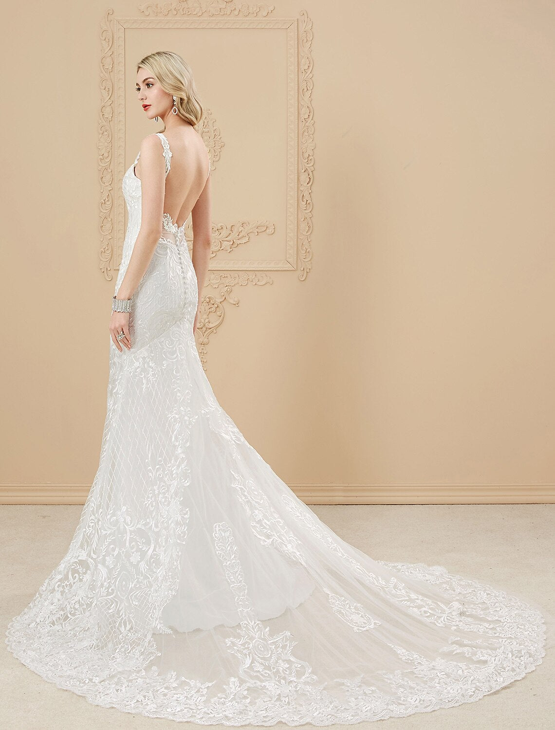 Close-up of the sweetheart neckline and spaghetti straps on the satin wedding dress.