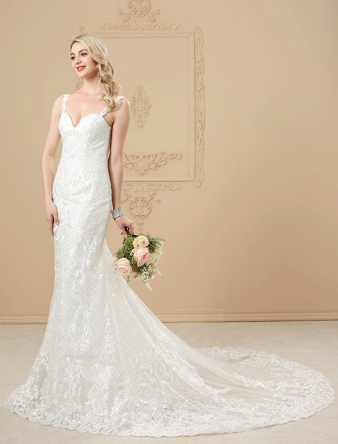Back view of the mermaid wedding dress, highlighting the chapel train and button details.