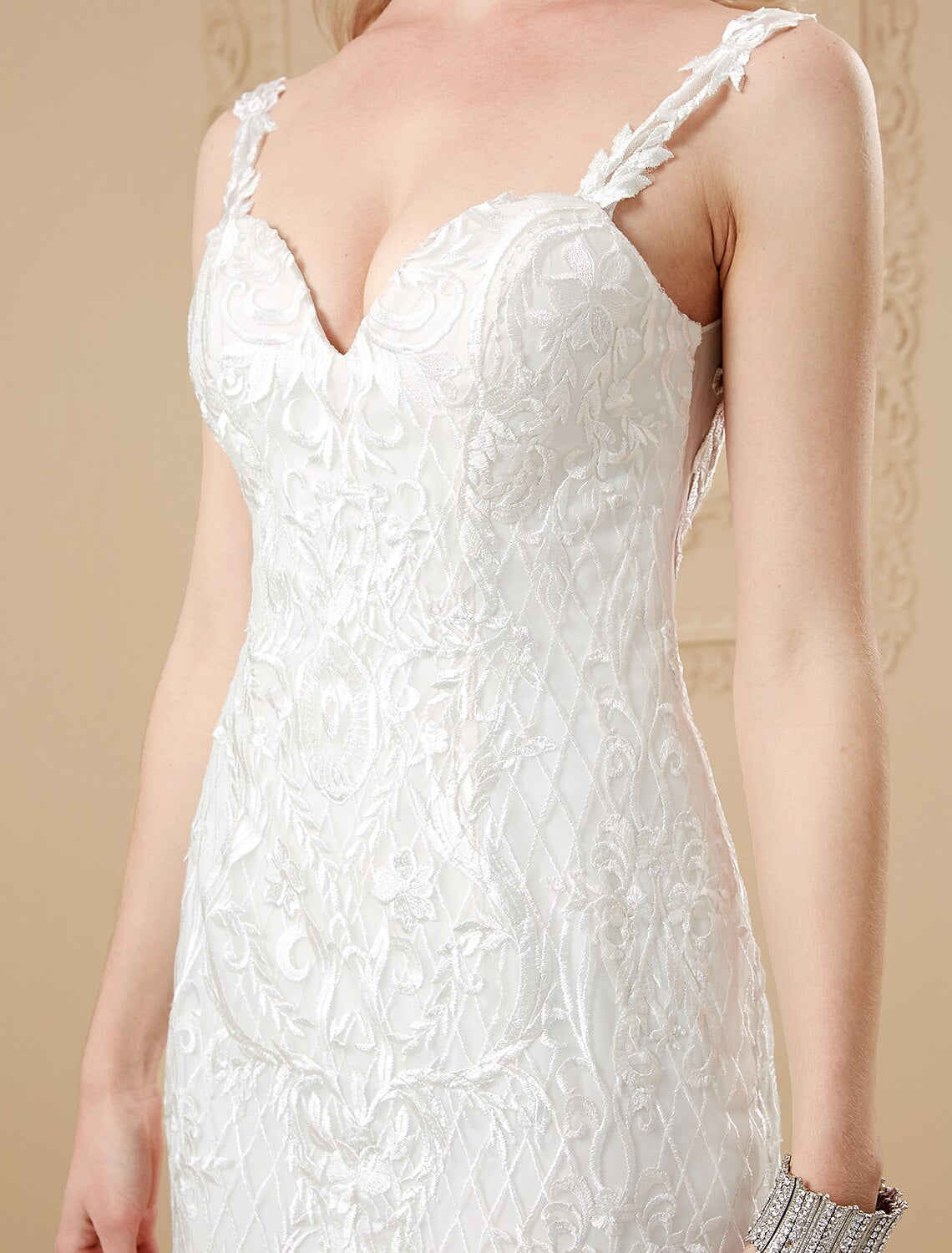 Side view of the bride in the satin mermaid gown, showcasing the silhouette.