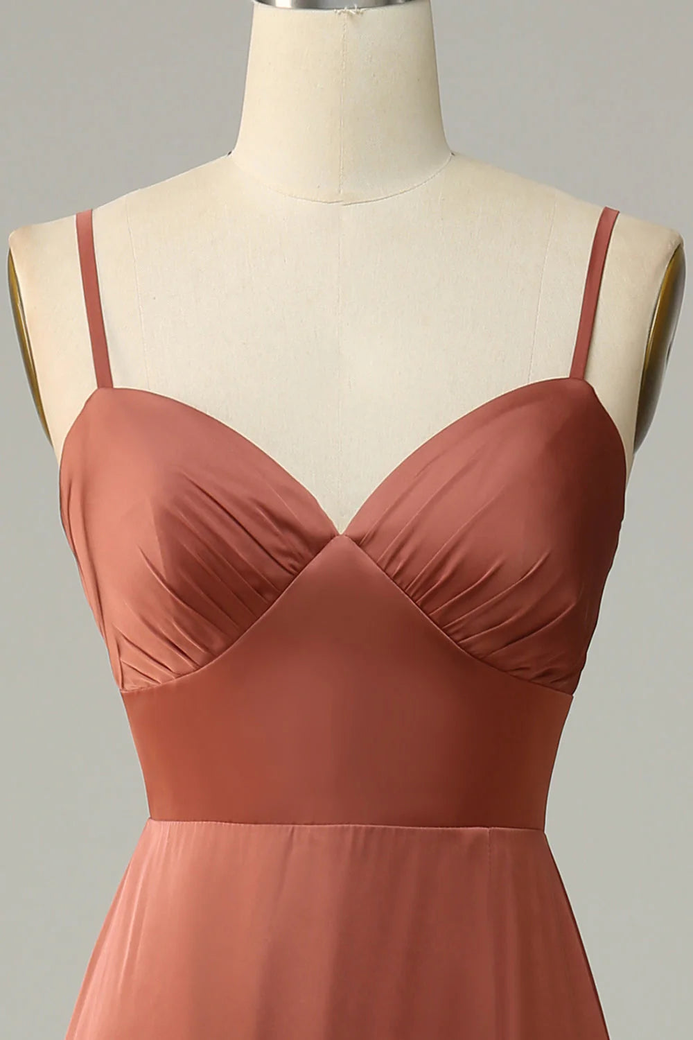 Back view of the brick red satin sheath dress, highlighting the elegant silhouette and flowing fabric.