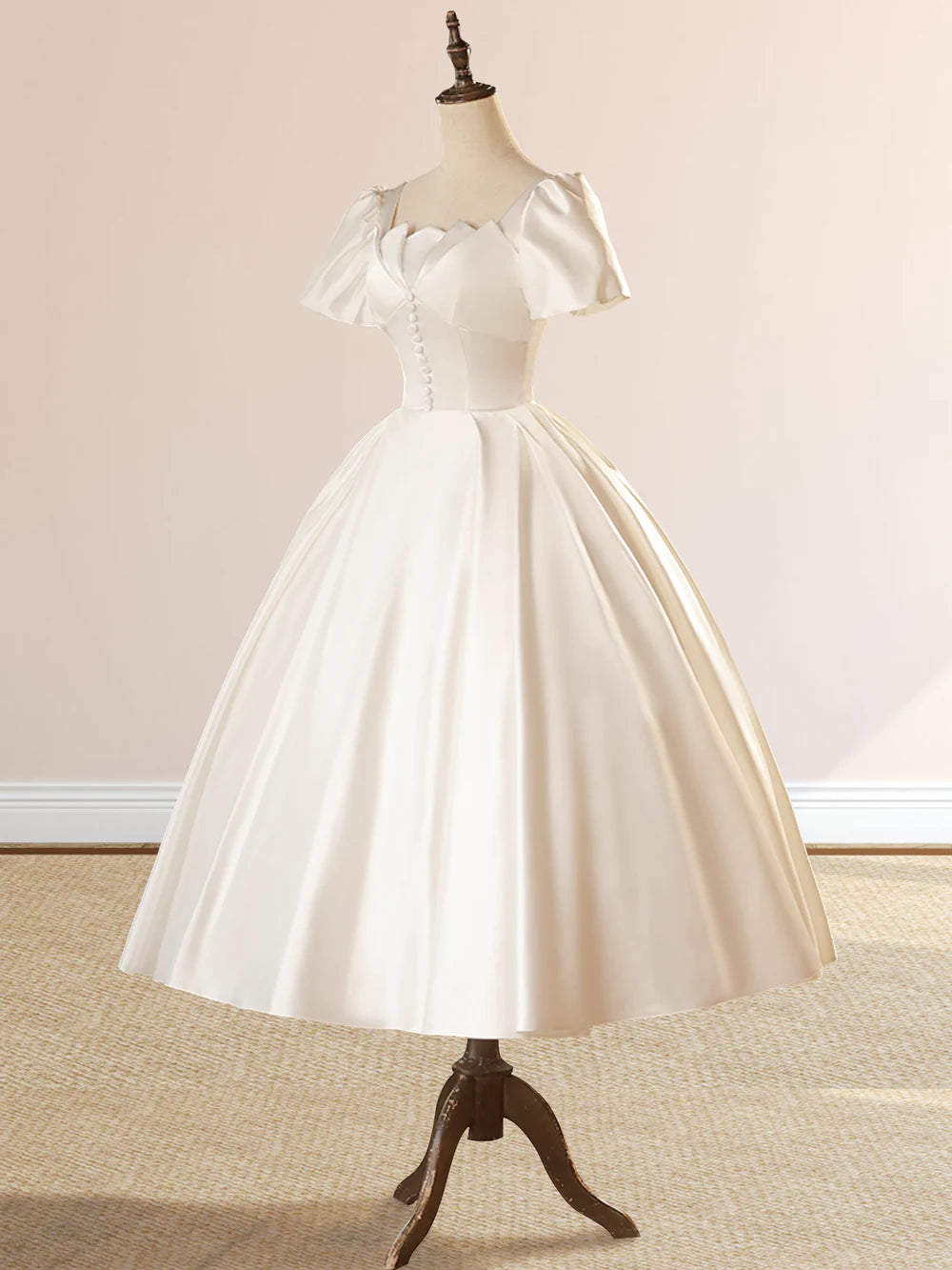 Detail shot of the satin fabric and the elegant drape of the wedding dress.