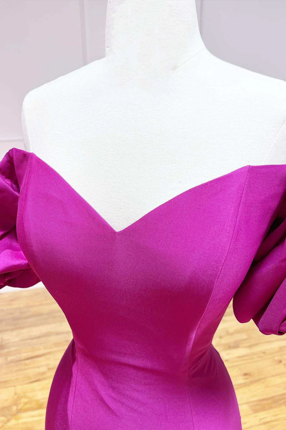 Back view of a woman in a sophisticated strapless satin trumpet long formal gown.