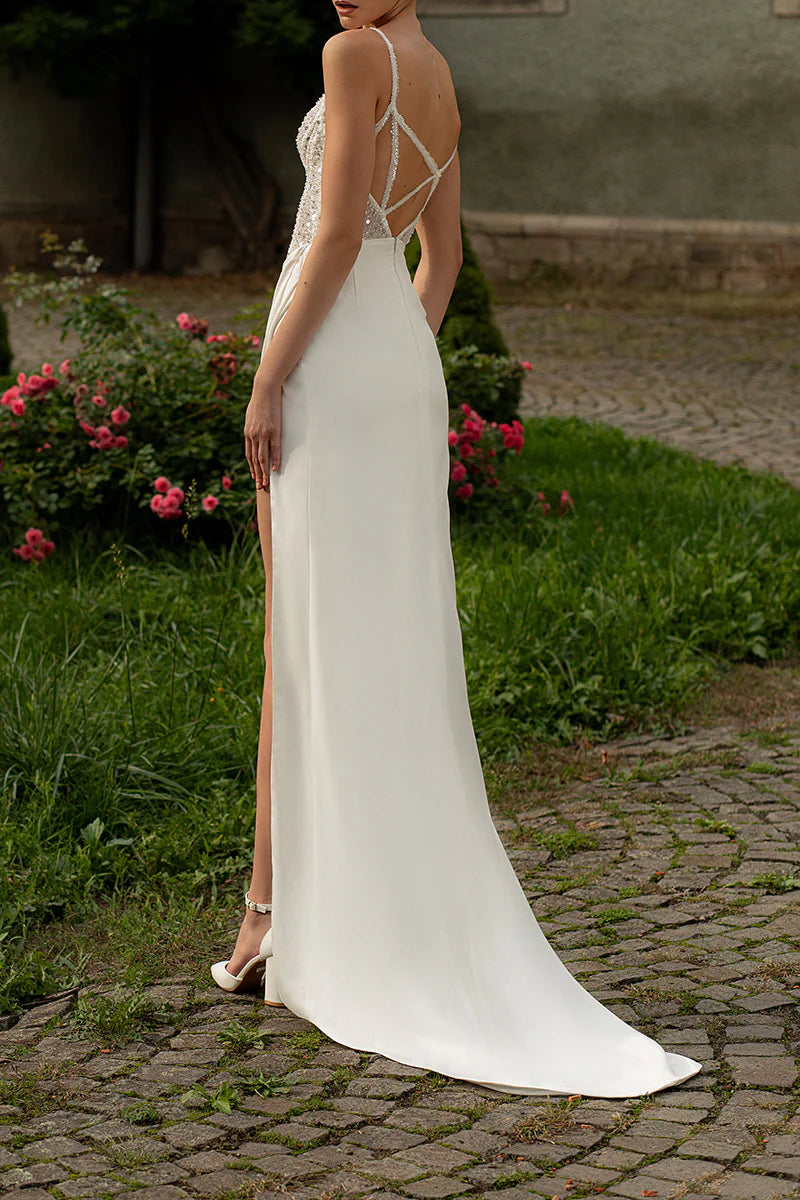 Back view of the satin V-neck wedding dress with delicate spaghetti straps.