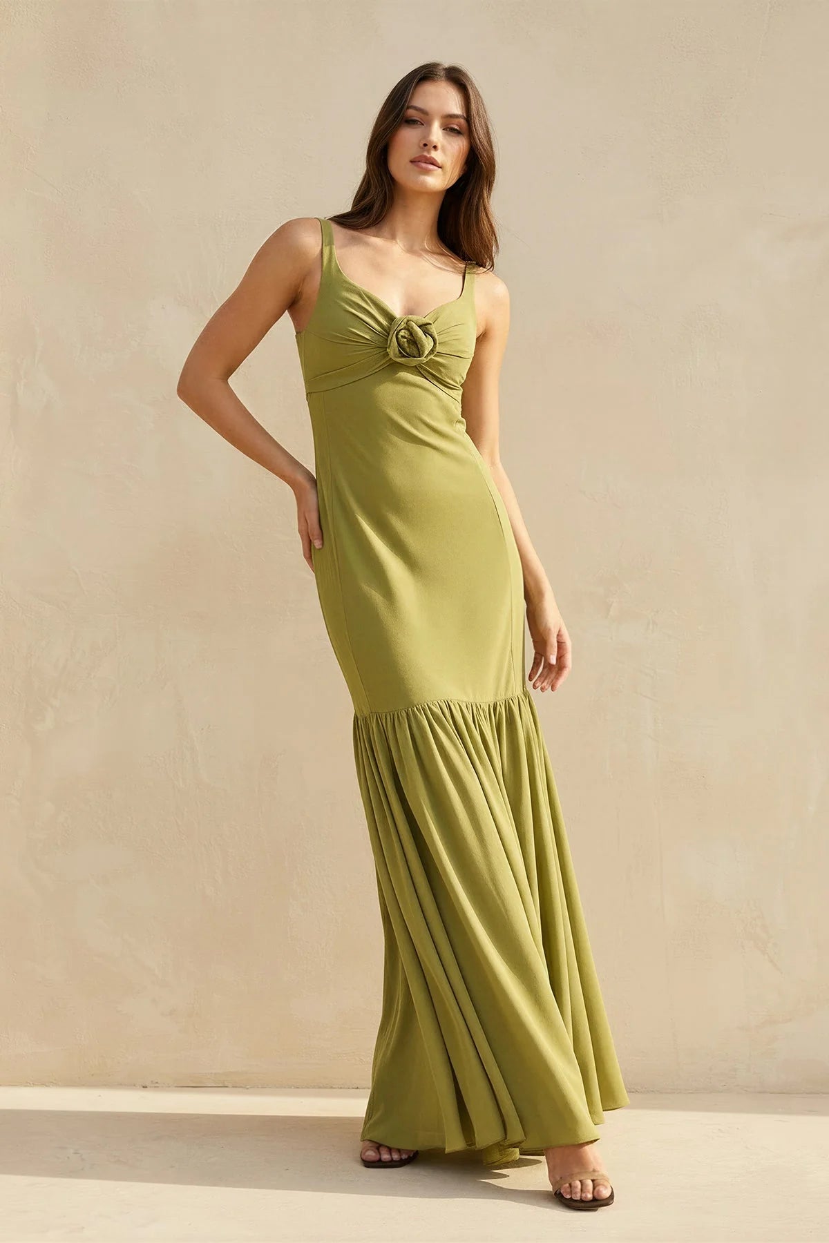 Elegant mermaid gown with scoop neck and floral rosette detail.