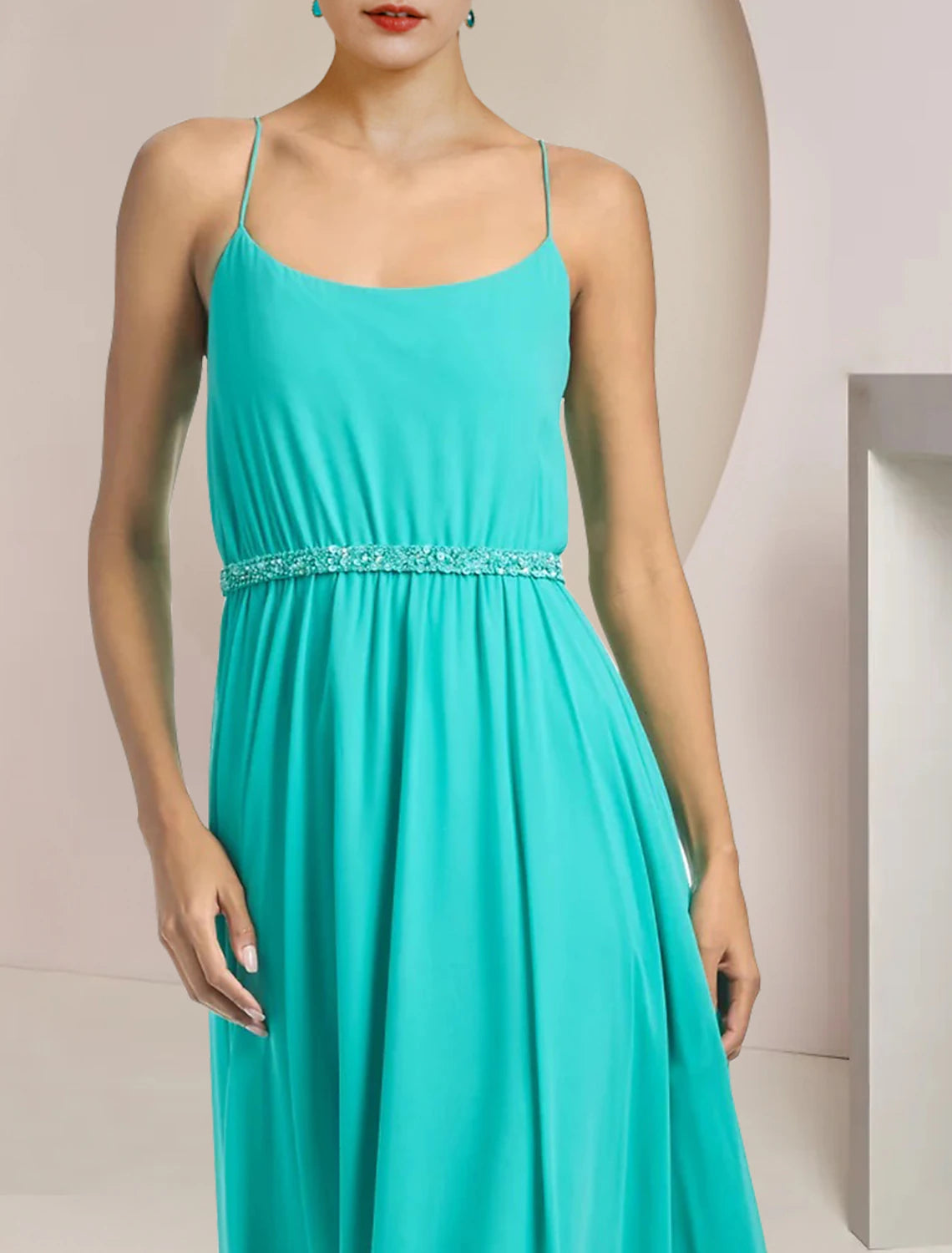 Elegant two-piece pantsuit styled for a formal wedding guest occasion.