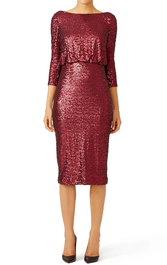 Elegant woman wearing a short sequin A-line Mother of the Bride dress with half sleeves, front view.