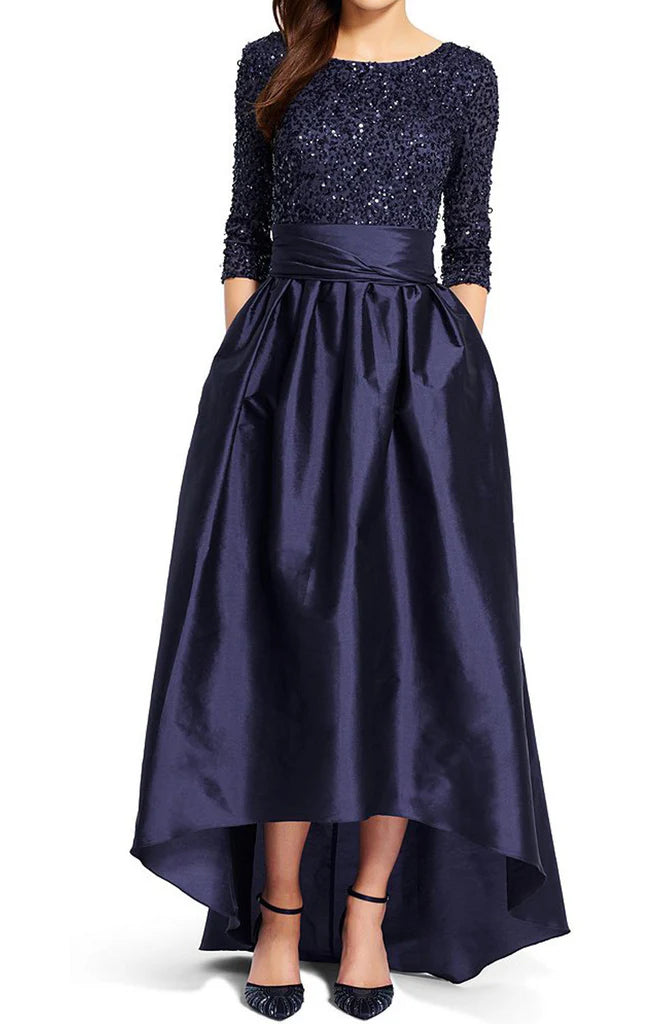 Woman wearing an elegant sequin half sleeve formal gown, suitable for Mother of the Bride.