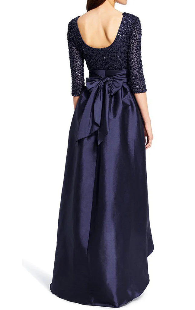Back view of a woman in a shimmering sequin formal dress with half sleeves.