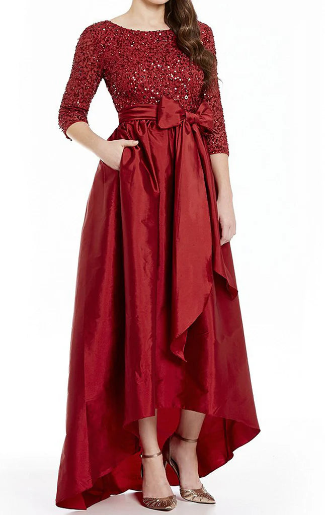 Side profile of a woman showcasing the sequin detailing on a formal half sleeve gown.