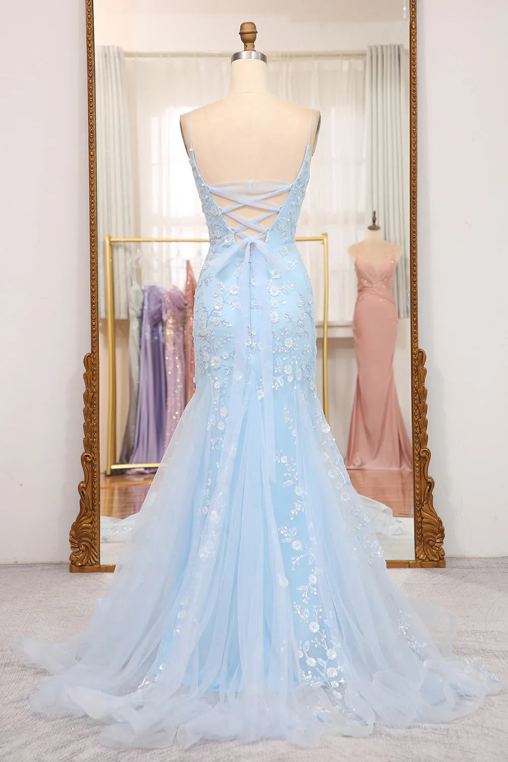 Side view of a model wearing the blue sequin mermaid prom dress, showcasing the silhouette.