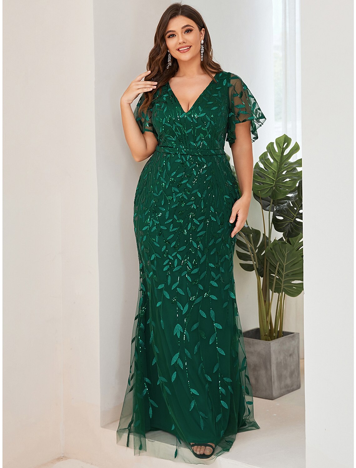 Woman walking in the floor length sequin formal dress.