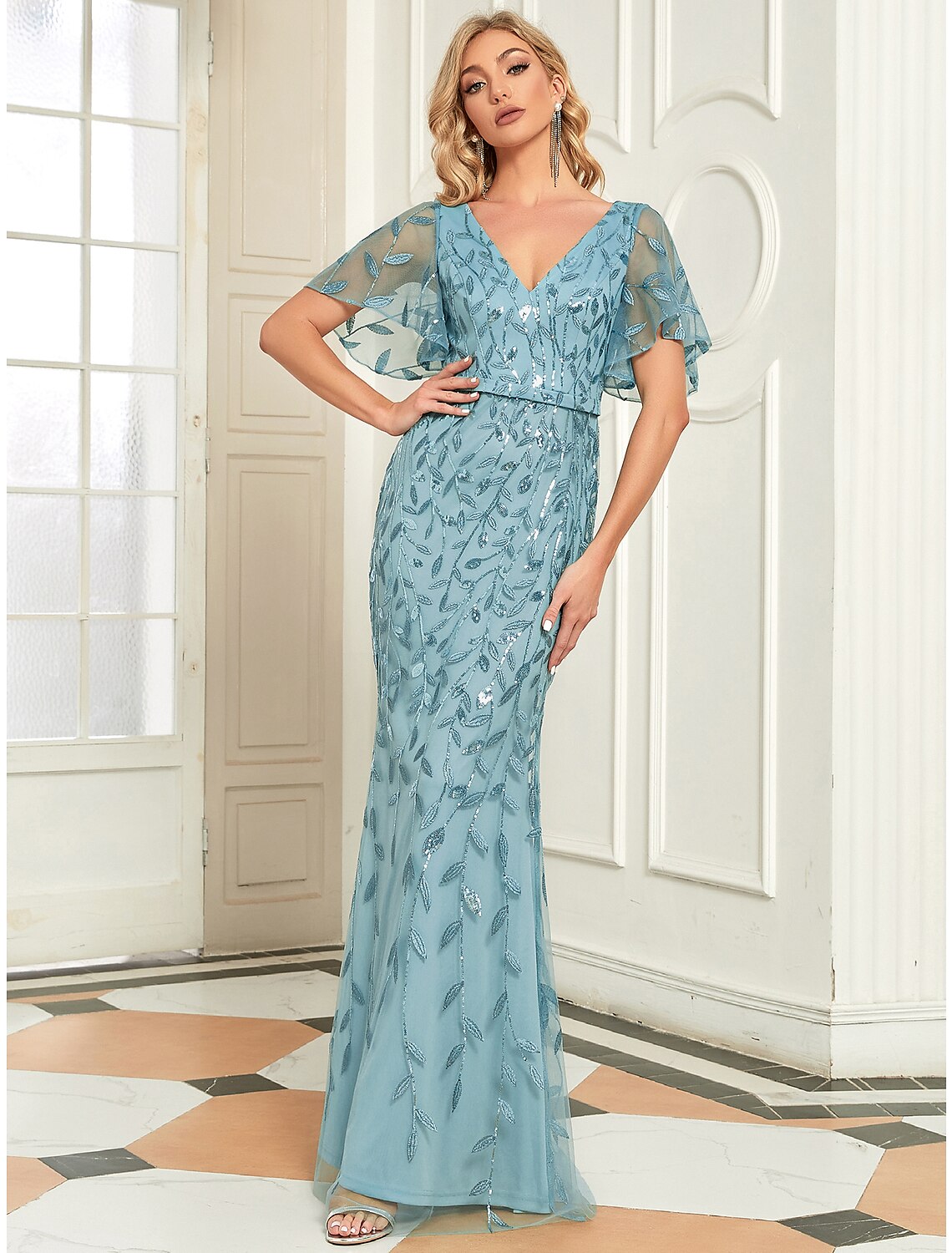 Detail of the V-neckline and short sleeves of the evening gown.
