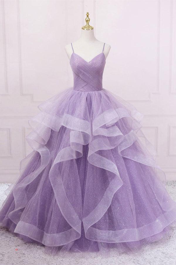 Elegant woman wearing a sequin bodice tulle long formal prom dress.