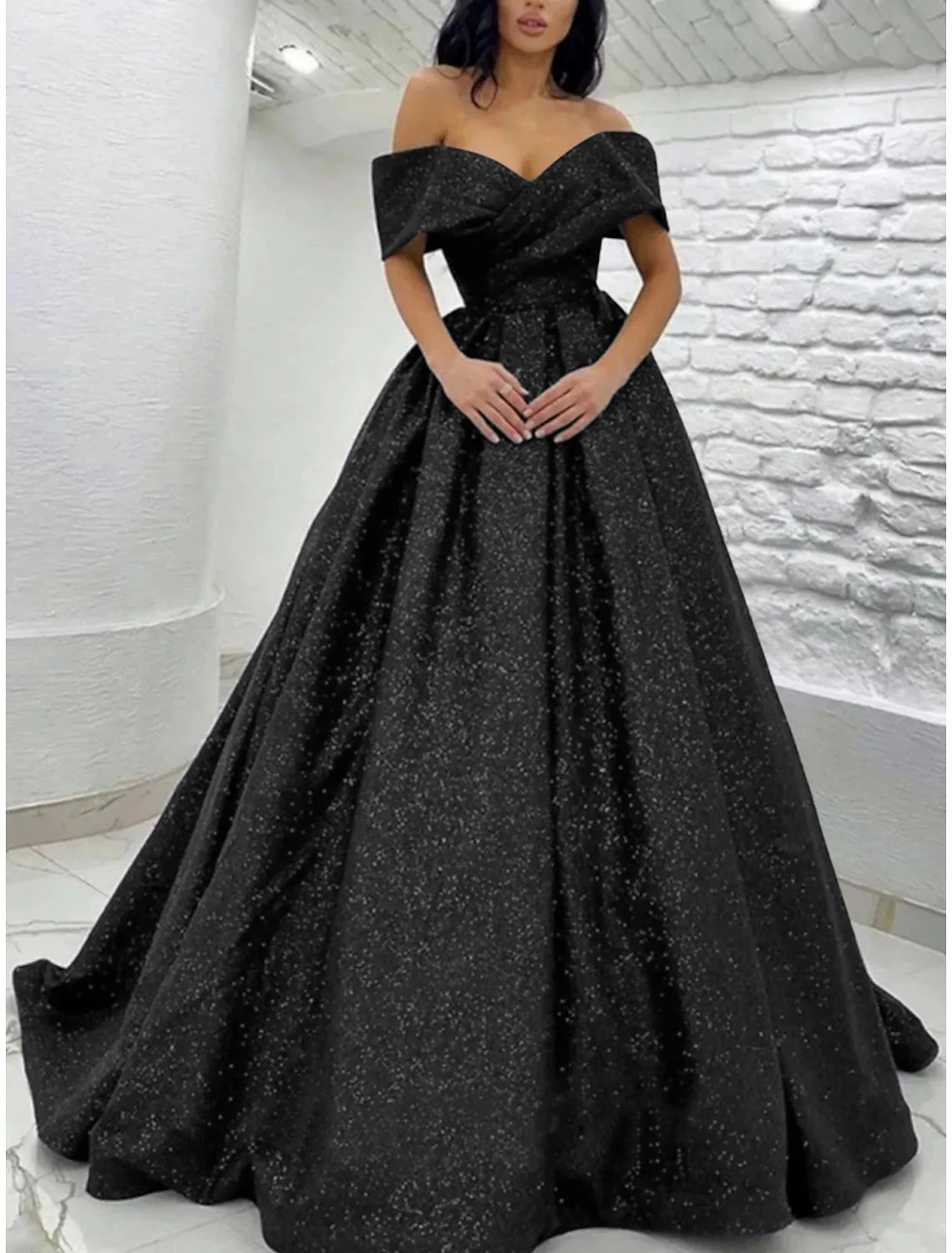 Back view of the sequined A-line prom dress showing the sweep train.