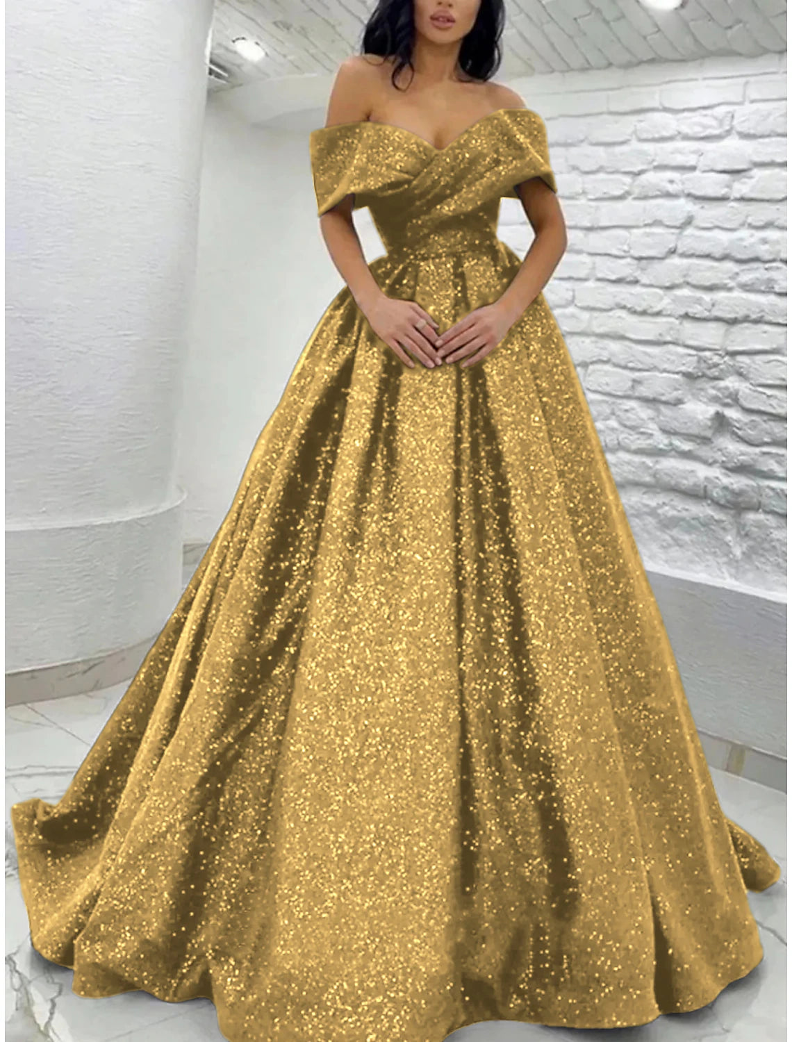 Model posing in the elegant off-shoulder short sleeve sequined gown.
