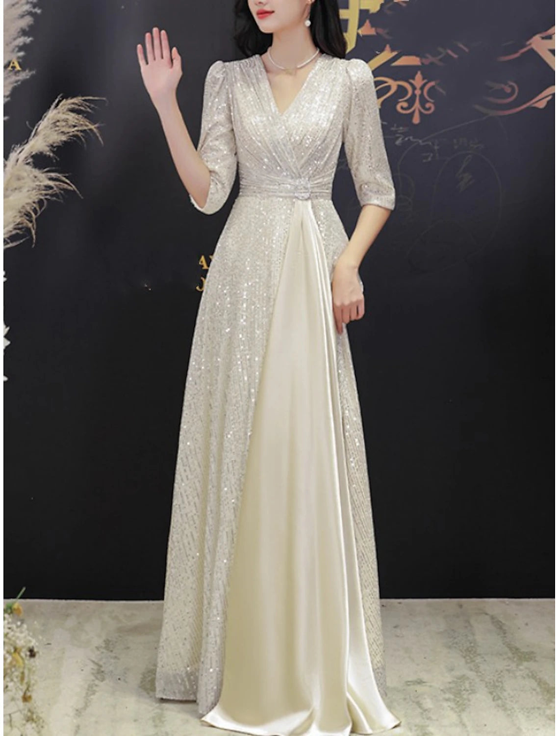 Elegant sequined A-line Mother of the Bride dress with V-neck and half sleeves.