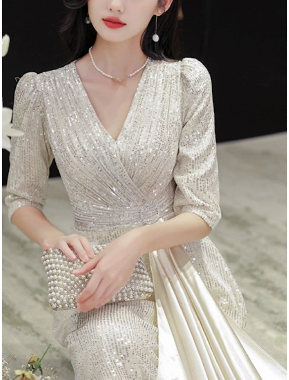 Back view of the A-line dress showcasing the sweep train and sequin details.