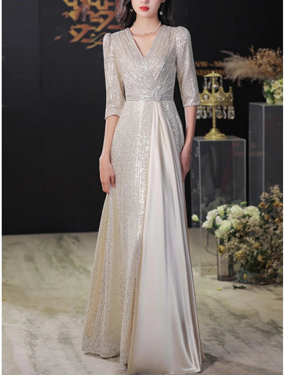 Side profile of the A-line Mother of the Bride dress with elegant pleats.