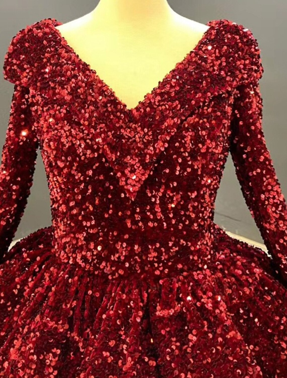 Back view of a luxurious floor-length sequined ball gown.